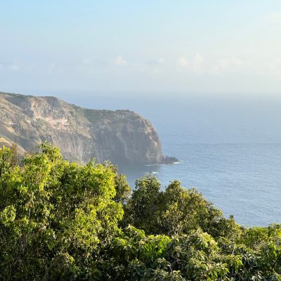 a large body of water with a mountain in the background