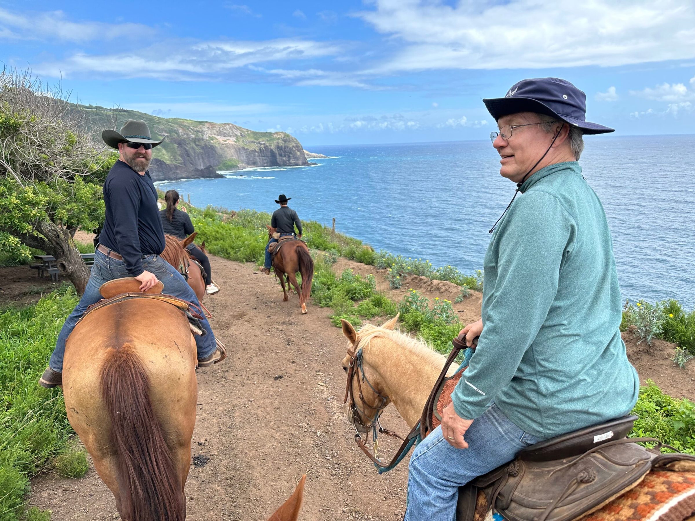 a man riding a horse next to a body of water