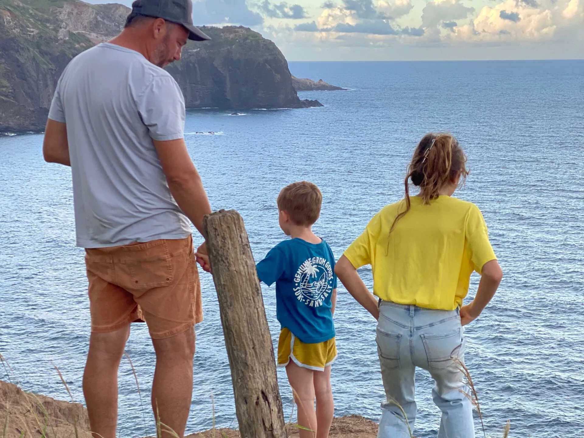a group of people standing next to a body of water